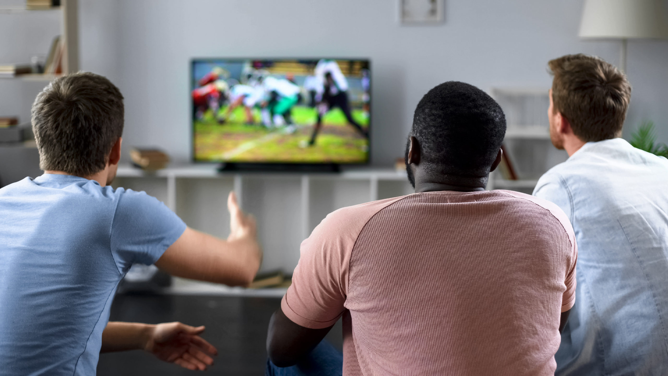Friends watch football on TV