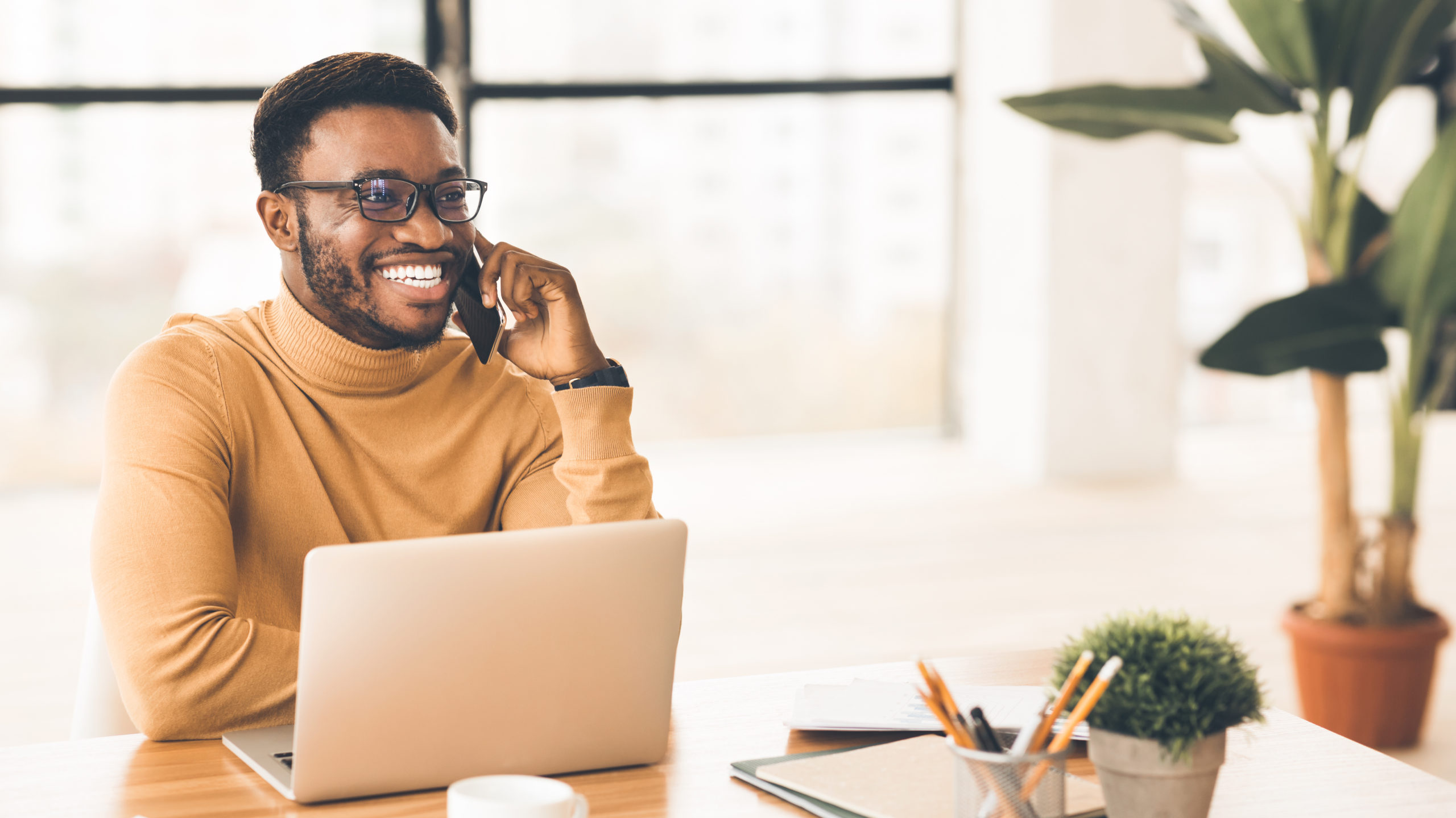 Man talking on cell phone at office