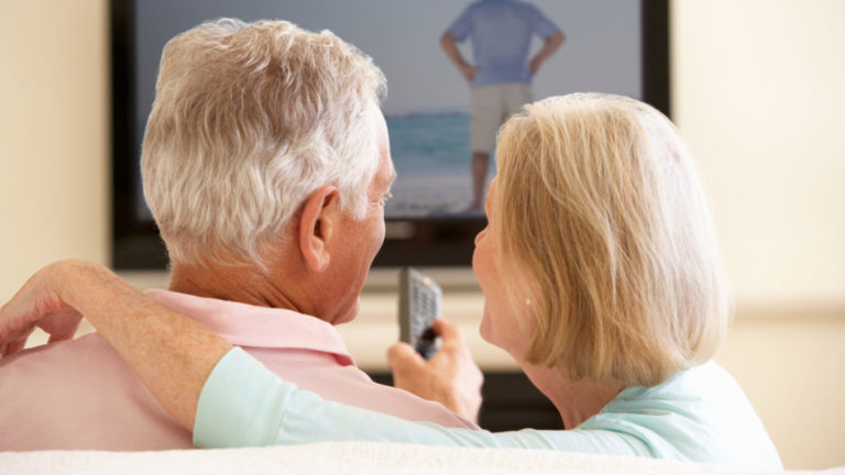 Senior Couple Watching TV At Home.