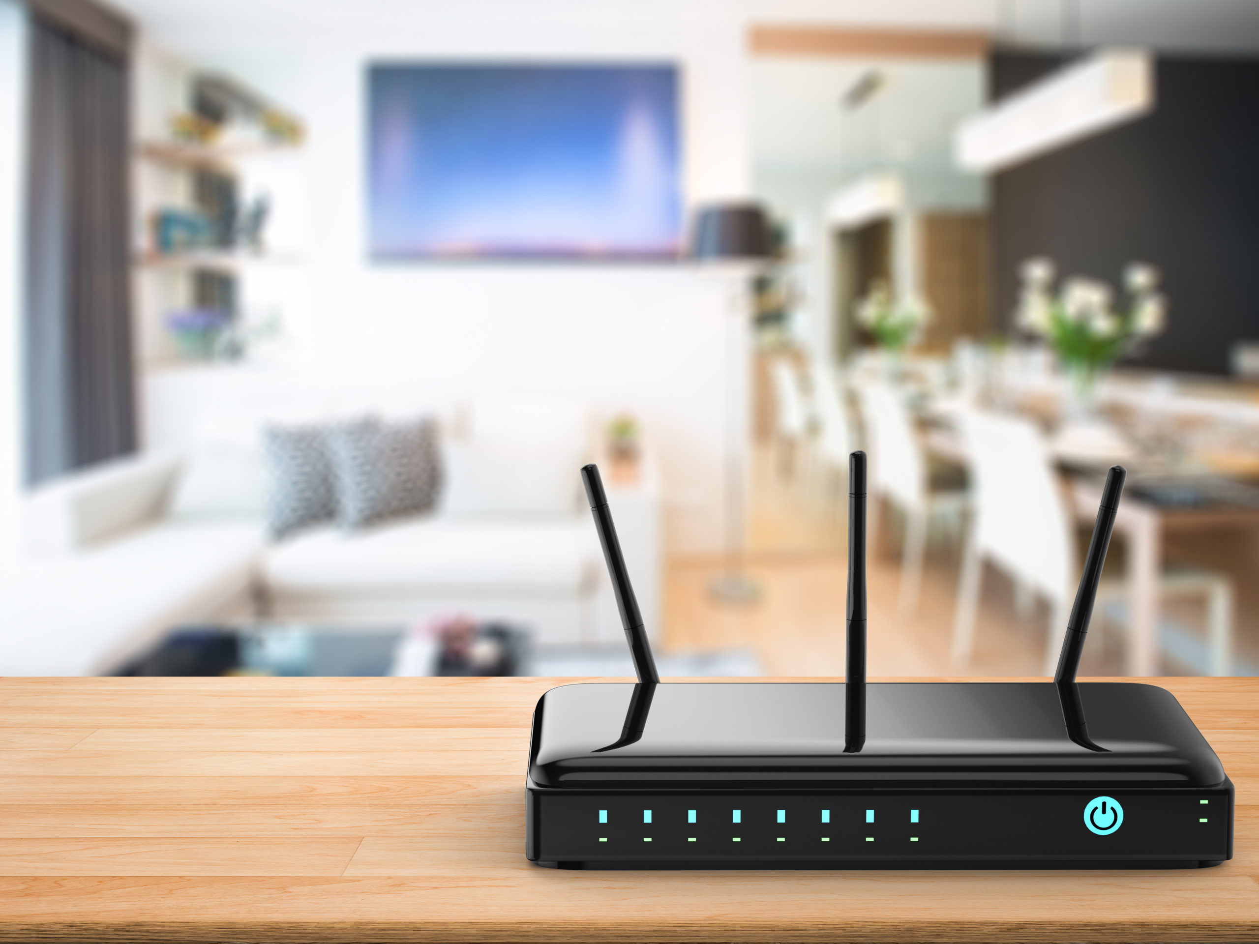 Wi-Fi router on table with TV in background